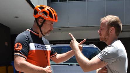 fat cyclist talking to car driver